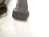 a small black object on the table next to a green bag