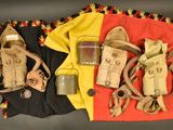 an old pair of gas masks and a gas can on a blanket