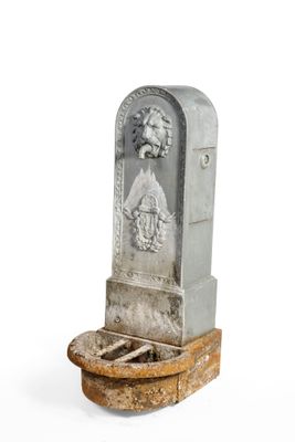 a stone statue of a man and a woman on a pedestal