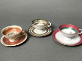 three different types of tea cups and saucers are sitting on a table