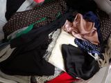 a suitcase full of clothes and clothes sitting on the floor
