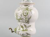 an image of a white and green vase with a lid