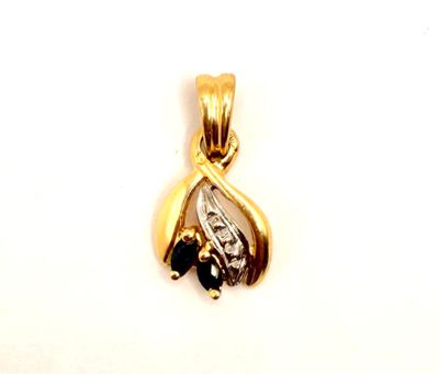 yellow gold pendant with black and white diamonds on a white background