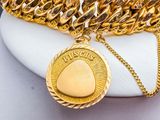 gold plated chain bracelet with a coin on a white plate