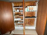 an open cabinet with a lot of items in it