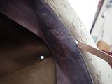 a close up of a person cutting a piece of leather