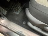 a close up of a car ' s floor mat with a foot rest