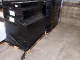 many black boxes stacked on pallets in a warehouse