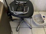 a chair that is sitting on the floor next to a bucket