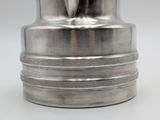 a silver vase that is sitting on a table