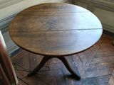 une table avec un plateau en bois posée sur un parquet
