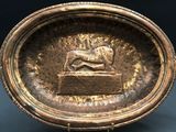 a bronze bowl with a lion on it