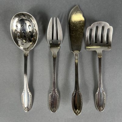 three spoons, a fork, and a spoon rest on a table