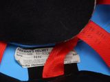 a black hat with a red ribbon on top of it