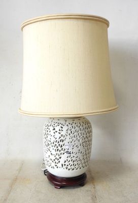 a lamp that is sitting on a table with a lamp shade on it