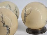 pair of white and black marbled glass lamps on wooden bases