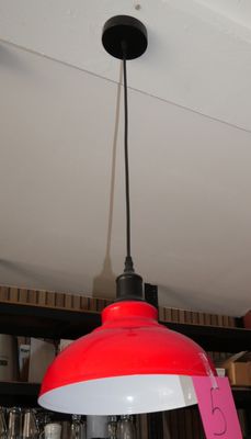 a red light hanging from the ceiling of a coffee shop