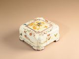 a small white box with a floral design on it