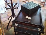 a suitcase sitting on top of a cart in the middle of a room