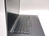 a black laptop with a blue keyboard on a white surface
