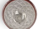 an overhead view of a clear glass bowl with a red rim