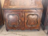 a small wooden cabinet with two doors and a drawer