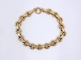 a close up of a gold bracelet on a white background