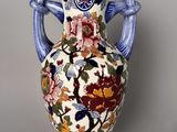 a vase with a floral design on it sitting on a table