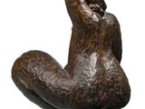 sculpture of a woman sitting on her back with her hands on her knees