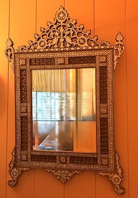 a mirror hanging on the wall in a room