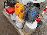 a pile of assorted items on a pallet on the ground