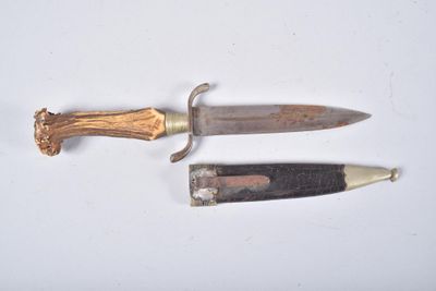 two different types of knives on a white surface