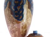 a vase with a lid sitting on a table