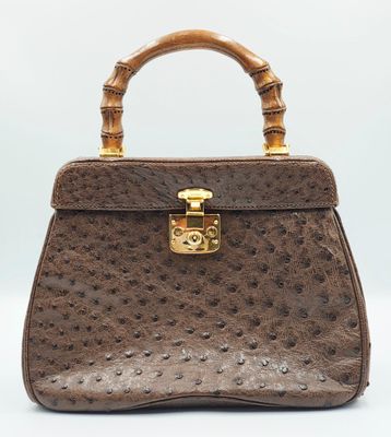 a brown ostrich ostrich leather handbag with bamboo handles