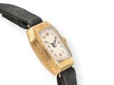 an image of a gold wrist watch with a black leather strap