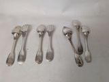six forks and spoons are lined up on a white surface