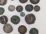 several different types of coins are displayed on a white surface
