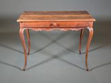 a small wooden table with a drawer on top of it