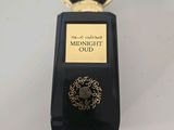 a close up of a bottle of perfume on a table