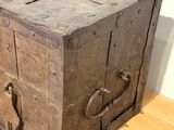 an old wooden chest sitting on a hard wood floor