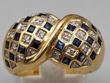 a close up of a gold ring with blue and white stones