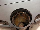 a metal trash can that has a hole in it