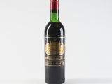a bottle of wine sitting on top of a white table
