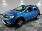 the blue dacia is parked on a checkered tile floor