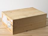 a wooden box sitting on a wooden floor