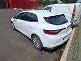a white car parked next to a white van in a parking lot
