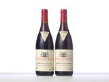 two bottles of red wine sitting next to each other on a table