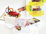 a red toy truck with a sign on the back of it