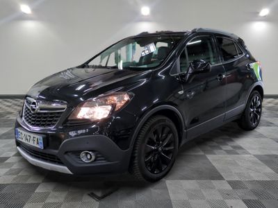 the black buick suv is parked in a large room