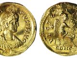 une pièce d'or portant l'image d'une femme et d'un homme